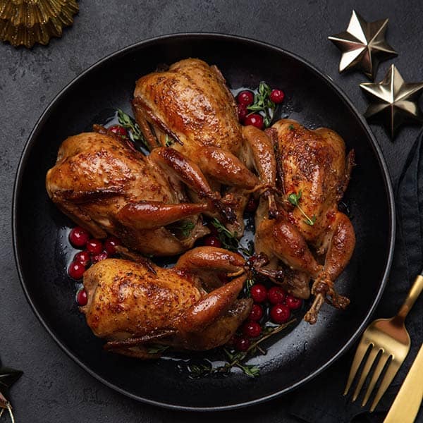Quail cooked and braised in a skillet