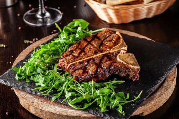 wet age steak on a bed of arugula